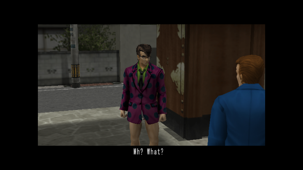 Our Yakuza Fury hero faces the camera, wearing sumo undergarments, a polka dot suit jacket, a green shirt, glasses and with bequiffed hair