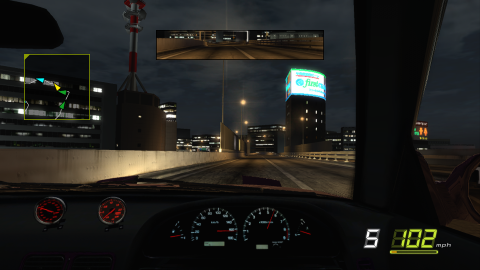 Another cockpit shot featuring some extra red boost guages. In the background we can see a building with a vibrant white and blue sign on top.